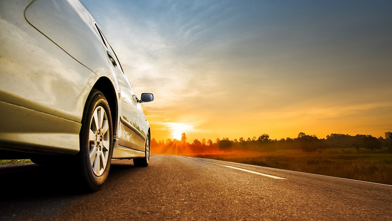 Car wheel with sunset in background