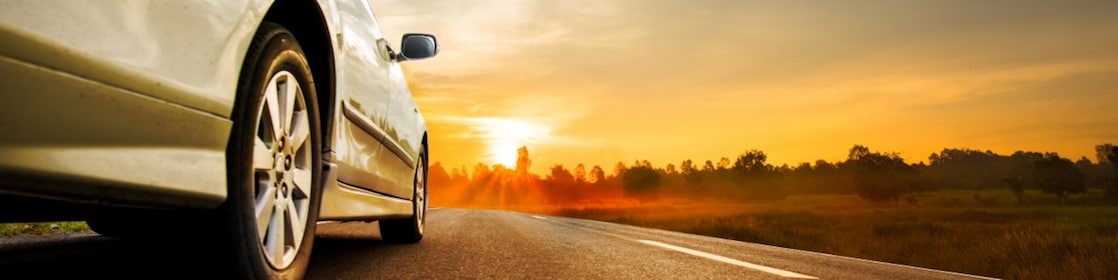 Car wheel with sunset in background
